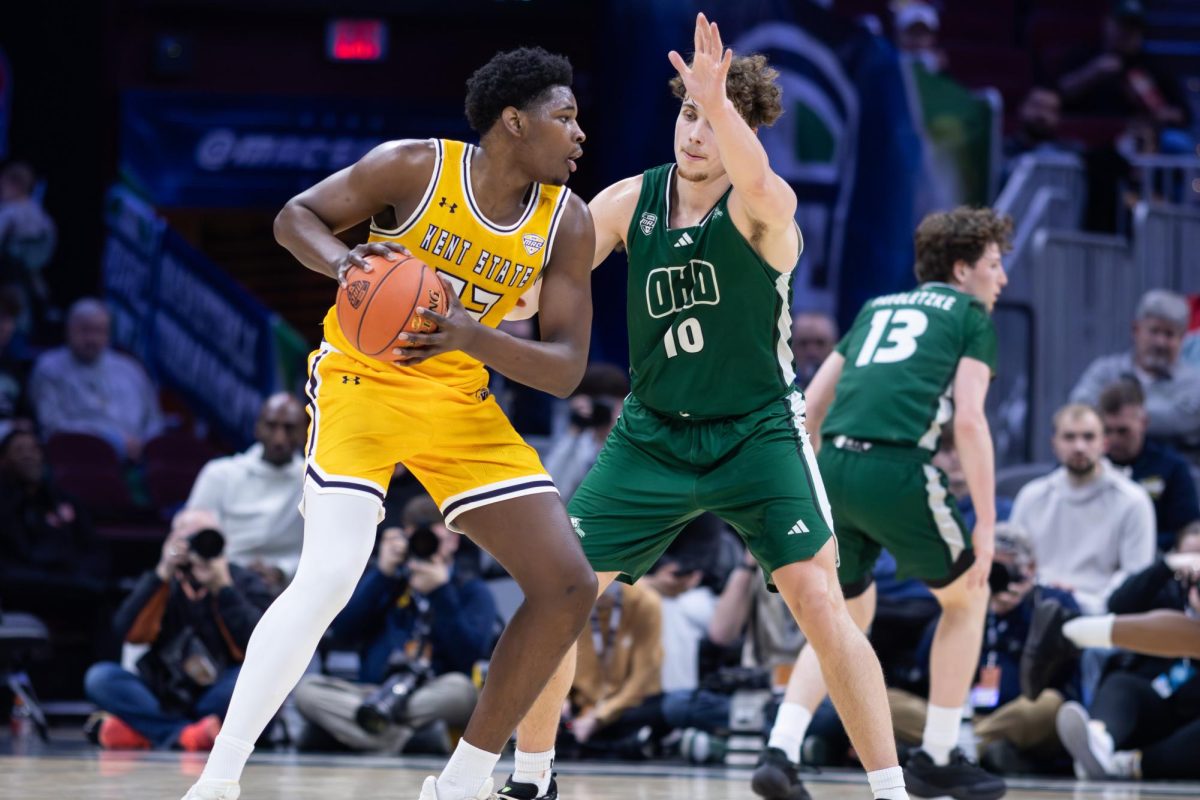 Kent senior Delrecco Gillespie attempts to drive to the basket against Ohio University senior Aidan Hadaway during the Quarterfinal round of the Mid-American Conference Tournament on March 12, 2026.