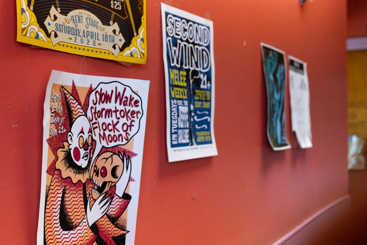 Taco Tontos hangs up fun artistic flyers for events around Kent, March 28, 2026. 