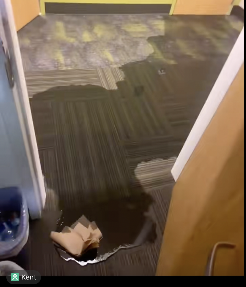 Screen-grab of a TikTok posted by @_.0nly1paipai, showing the water flooding the hallway of Korb Hall. 