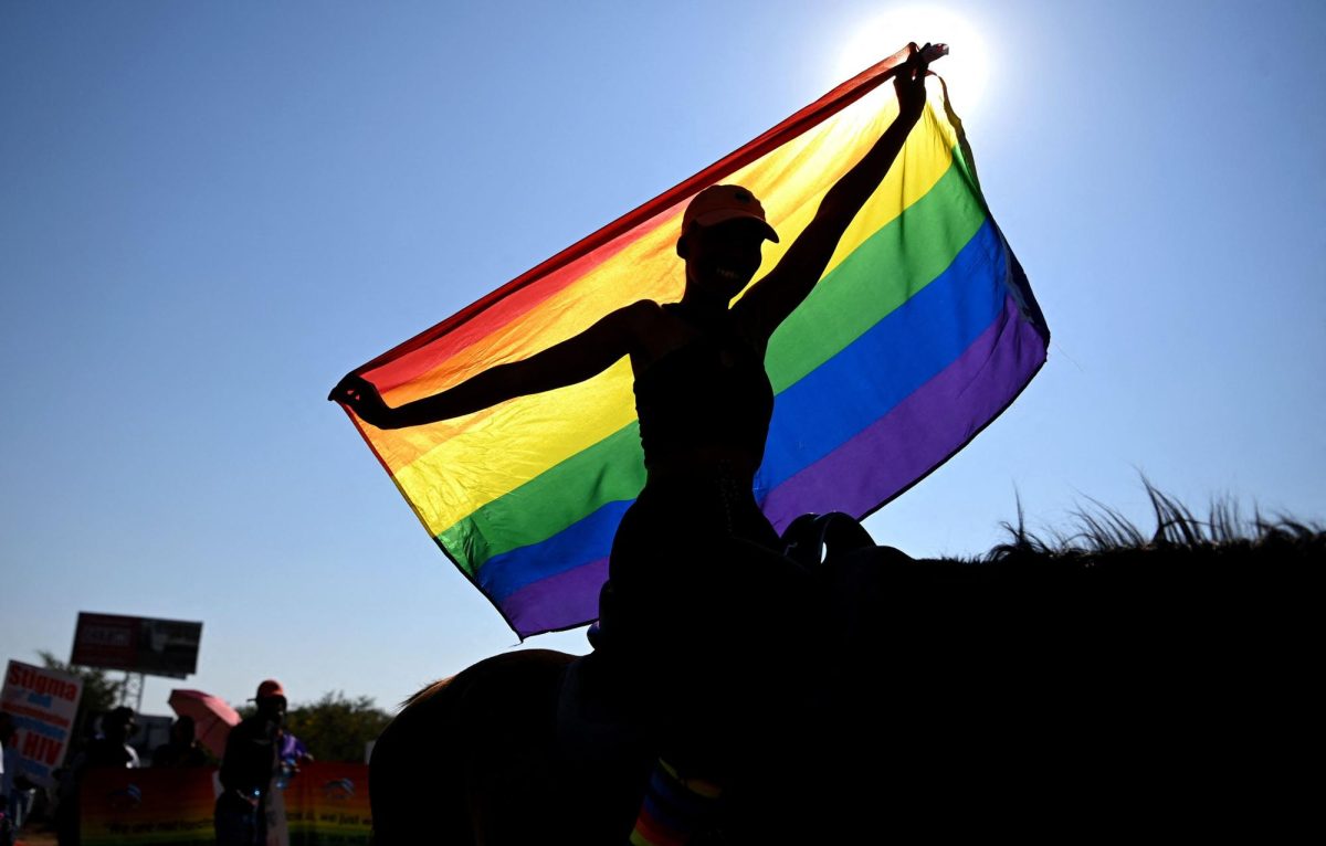 A person holds a rainbow flag while taking part in the annual Gaborone Pride march in Gaborone on October 7, 2023.