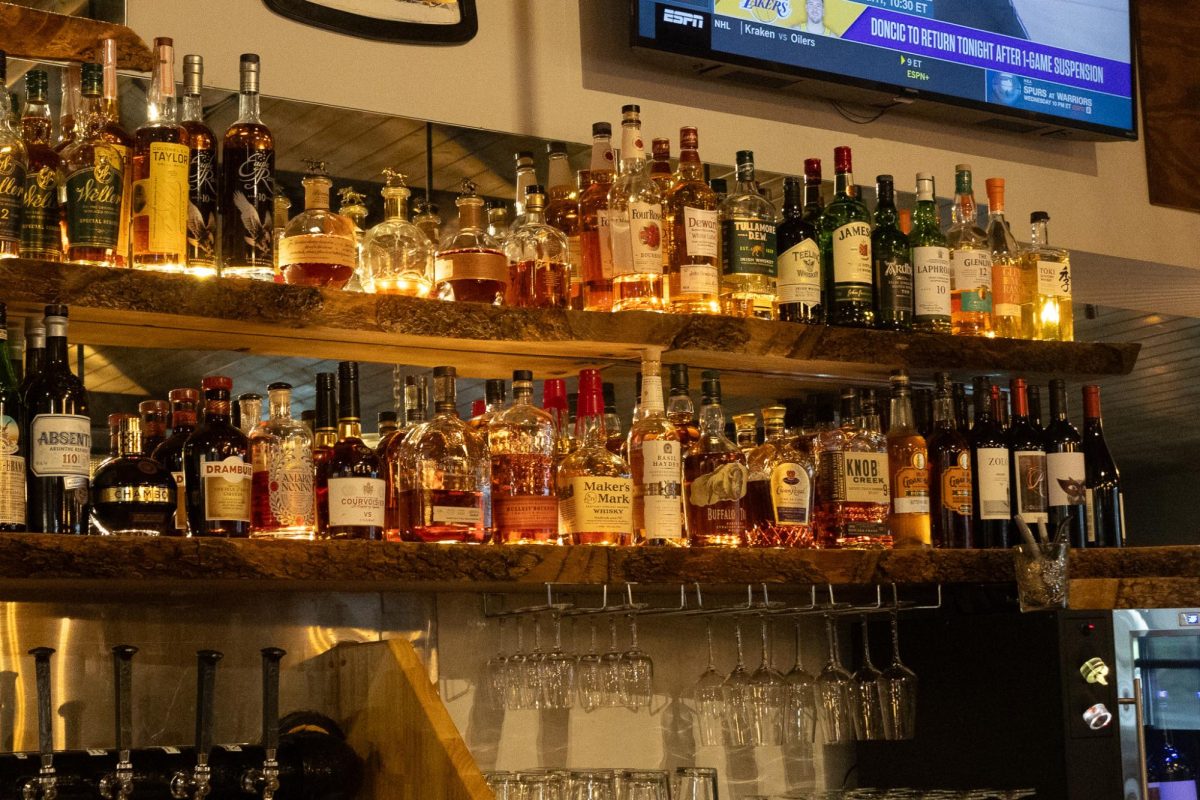 Bottles of alcohol on display for people to see and drink at the River Merchant on North Mantua St. on March 31, 2026.