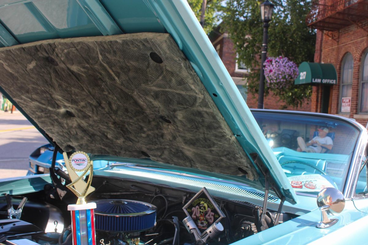 Car show participants display their engines and prior awards on July 3, 2026. 